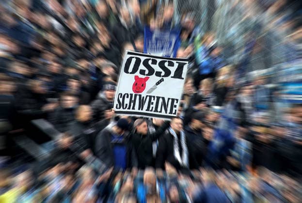 Fussball, Herren, 3.Liga, Saison 2025 2026, TSV 1860 München - FC Hansa Rostock, Grünwalder Stadion Eine Fahne, Banner Ossi Schweine in der Westkurve, TSV 1860, Ultras *** Football, Men, 3 Liga, Season 2025 2026, TSV 1860 München FC Hansa Rostock, Grünwalder Stadion One flag, Banner Ossi Schweine in der Westkurve, TSV 1860, Ultras