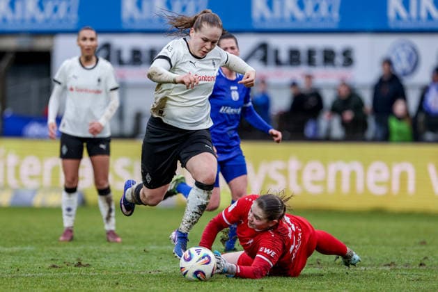 v.li.: Mia Giesen (Borussia Mönchengladbach, 19) legt den Ball an Isabel Rutishauser (Torhüterin, Torwart, SV Meppen, 28) vorbei, im Zweikampf, Duell, Dynamik, Aktion, Action, Spielszene, DIE DFB-RICHTLINIEN UNTERSAGEN JEGLICHE NUTZUNG VON FOTOS ALS SEQUENZBILDER UND ODER VIDEOÄHNLICHE FOTOSTRECKEN. DFB REGULATIONS PROHIBIT ANY USE OF PHOTOGRAPHS AS IMAGE SEQUENCES AND OR QUASI-VIDEO., 22.02.2026, Meppen (Deutschland), Fussball, 2. Frauen-Bundesliga, SV Meppen - Borussia Mönchengladbach