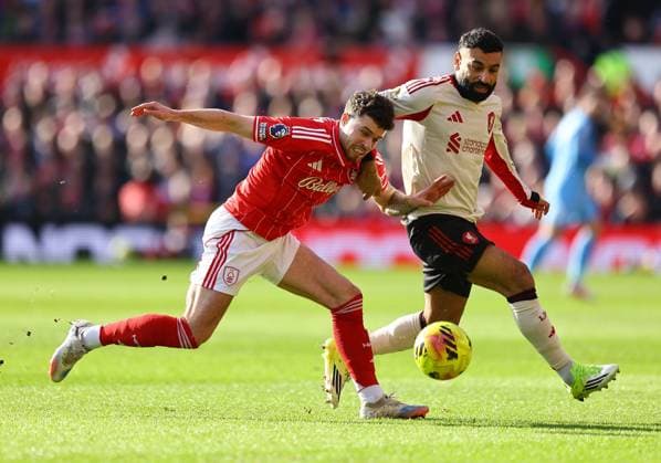 Mohamed Salah of Liverpool competes for the ball with Neco Williams of Nottingham Forest Nottingham Forest v Liverpool, Premier League, Football, City Ground, Nottingham, UK - 22 Feb 2026Nottingham City Ground United Kingdom EDITORIAL USE ONLY No use with unauthorised audio, video, data, fixture lists, club league logos or live services. Online in-match use limited to 120 images, no video emulation. No use in betting, games or single club league player publications. Copyright: xMichaelxZemanek Shutterstockx 16681559j