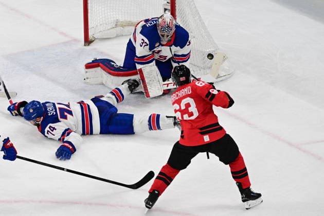 XXV Winter Olympic Games, Olympische Spiele, Olympia, OS in Milan, Italy, on February 22, 2026. Men s Ice hockey, Eishockey final, Canada vs USA. From left: Jaccob Slavin (USA), goalkeeper Connor Hellebuyck (USA) and Brad Marchand (CAN). (CTKxPhoto MichalxKamaryt) CTKPhotoP2026022204241  CTKPhotoP2026022204241