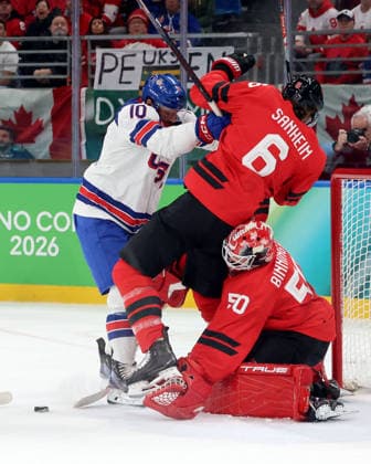 February 22, 2026, Milan, Italy: TRAVIS SANHEIM of Canada is checked by JT MILLER of USA as Canada goaltender Jordan Binnington reaches for puck in the men s Ice hockey, Eishockey gold medal game during the Milano Cortina 2026 Olympic Winter games, Winterspiele,Spiele, Summer games Milan Italy - ZUMAm117 20260222_oly_m117_008 Copyright: xDavidxMcIntyrex
