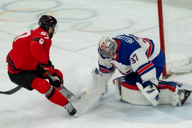 February 22, 2026, Milano, Lombardy, Italy: Connor Hellebuyck (37) of the United States saber a goal on shot by Connor McDavid (97) of Canada during the second period in the Gold medal Ice hockey, Eishockey Men game during the 2026 Winter Olympics at the Milano Santagiulia Ice Hockey Arena on Sunday in Milano. Milano Italy - ZUMAj89_ 20260222_oly_j89_014 Copyright: xPaulxKitagakixJr.x