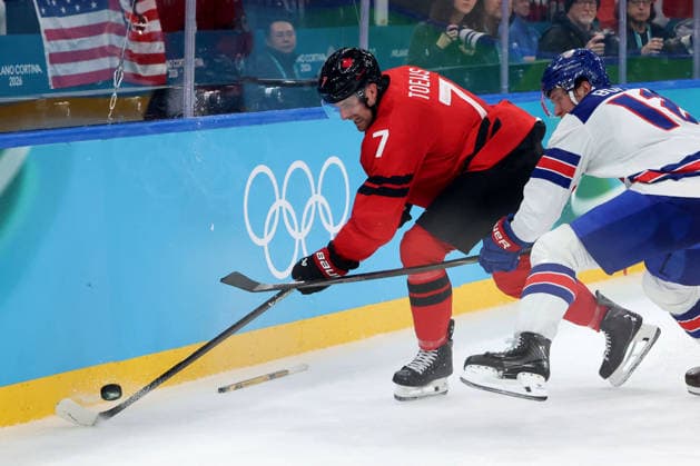 February 22, 2026, Milan, Lombardy, Italy: Devon Toews (7) of Team Canada and Matt Boldy (12) of Team United States in the men s Ice hockey, Eishockey gold medal game during the Milano Cortina 2026 Olympic Winter games, Winterspiele,Spiele, Summer games at Milano Santagiulia Ice Hockey Arena. Milan Italy - ZUMAm117 20260222_oly_m117_019 Copyright: xDavidxMcIntyrex