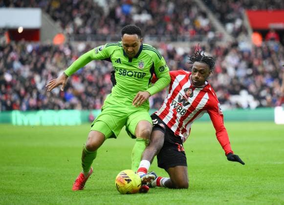 Romaine Mundle of Sunderland challenges Kenny Tete of Fulham Sunderland v Fulham, Premier League, Football, Stadium of Light, Sunderland, UK - 22 Feb 2026Sunderland Stadium of Light United Kingdom EDITORIAL USE ONLY No use with unauthorised audio, video, data, fixture lists, club league logos or live services. Online in-match use limited to 120 images, no video emulation. No use in betting, games or single club league player publications. Copyright: xRichardxLee Shutterstockx 16681560cc