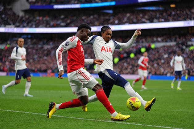 22nd February 2026; Tottenham Hotspur Stadium, London, England; Premier League Football, Tottenham Hotspur versus Arsenal; Bukayo Saka of Arsenal under pressure from Djed Spence of Tottenham Hotspur  JPxFletcher Content restricted for UK based newspaper