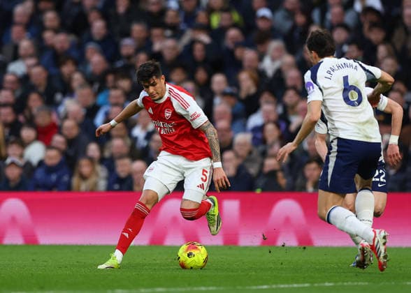 22nd February 2026; Tottenham Hotspur Stadium, London, England; Premier League Football, Tottenham Hotspur versus Arsenal; Piero Hincapie of Arsenal under pressure from Joao Palhinha of Tottenham Hotspur  JPxFletcher Content restricted for UK based newspaper
