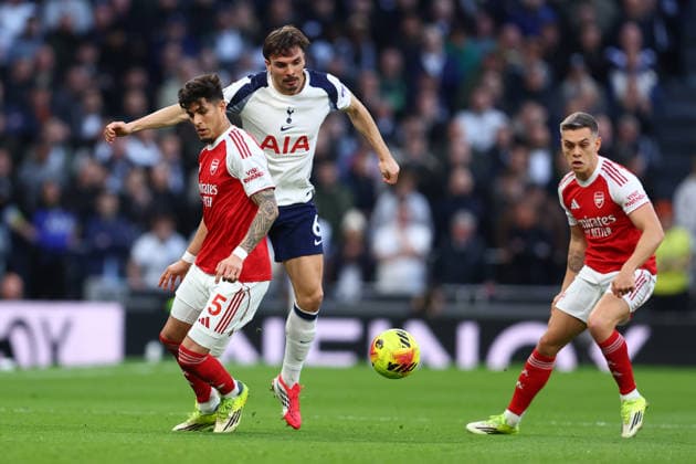 London, England, 22nd February 2026. Piero Hincapie of Arsenal and Joao Palhinha of Tottenham Hotspur challenge for the ball during the Tottenham Hotspur vs Arsenal Premier League match at the Tottenham Hotspur Stadium, London. Picture credit should read: Paul Terry Sportimage EDITORIAL USE ONLY. No use with unauthorised audio, video, data, fixture lists, club league logos or live services. Online in-match use limited to 120 images, no video emulation. No use in betting, games or single club league player publications. SPI_017_PT_Tottenham_Arsenal SPI-4545-0017