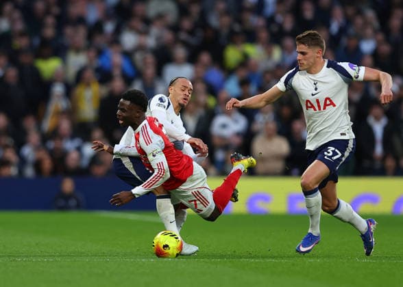 22nd February 2026; Tottenham Hotspur Stadium, London, England; Premier League Football, Tottenham Hotspur versus Arsenal; Bukayo Saka of Arsenal tackled by Xavi Simons of Tottenham Hotspur while under pressure from Micky van de Ven of Tottenham Hotspur  JPxFletcher Content restricted for UK based newspaper