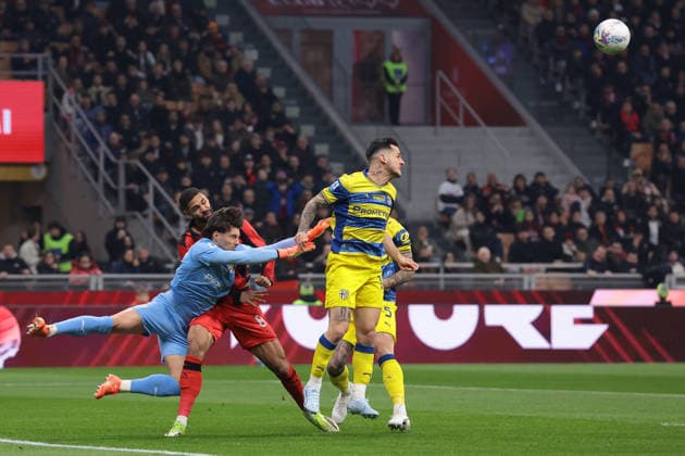 Milan, Italy, 22nd February 2026. Edoardo Corvi of Parma Calcio clahses with Ruben Loftus-Cheek of AC Milan as Emanuele Valeri of Parma Calcio heads the ball clear during the AC Milan vs Parma Serie A match at Giuseppe Meazza, Milan. Picture credit should read: Jonathan Moscrop Sportimage EDITORIAL USE ONLY. No use with unauthorised audio, video, data, fixture lists, club league logos or live services. Online in-match use limited to 120 images, no video emulation. No use in betting, games or single club league player publications. SPI_004_MILAN_PARMA SPI-4549-0004