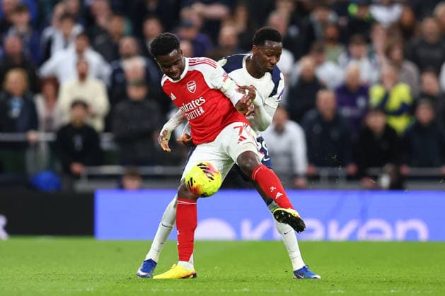 London, England, 22nd February 2026. Bukayo Saka of Arsenal and Pape Matar Sarr of Tottenham Hotspur challenge for the ball during the Tottenham Hotspur vs Arsenal Premier League match at the Tottenham Hotspur Stadium, London. Picture credit should read: Paul Terry Sportimage EDITORIAL USE ONLY. No use with unauthorised audio, video, data, fixture lists, club league logos or live services. Online in-match use limited to 120 images, no video emulation. No use in betting, games or single club league player publications. SPI_040_PT_Tottenham_Arsenal SPI-4545-0040