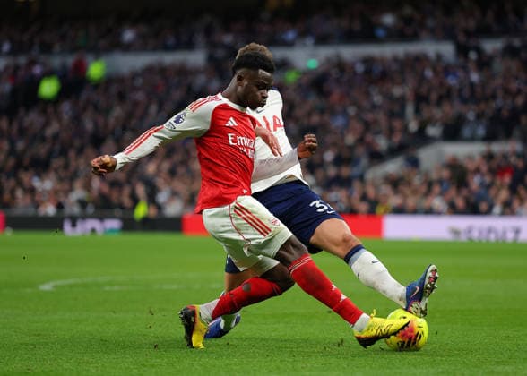 22nd February 2026; Tottenham Hotspur Stadium, London, England; Premier League Football, Tottenham Hotspur versus Arsenal; Bukayo Saka of Arsenal under pressure from Micky van de Ven of Tottenham Hotspur  JPxFletcher Content restricted for UK based newspaper