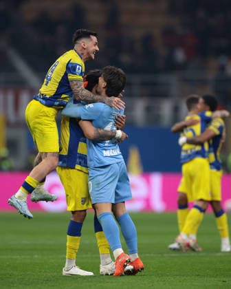 Milan, Italy, 22nd February 2026. Emanuele Valeri and Edoardo Corvi of Parma Calcio celebrate with team mate a goalscorer Mariano Troilo following the 1-0 victory for the visitors in the AC Milan vs Parma Serie A match at Giuseppe Meazza, Milan. Picture credit should read: Jonathan Moscrop Sportimage EDITORIAL USE ONLY. No use with unauthorised audio, video, data, fixture lists, club league logos or live services. Online in-match use limited to 120 images, no video emulation. No use in betting, games or single club league player publications. SPI_096_MILAN_PARMA SPI-4549-0096