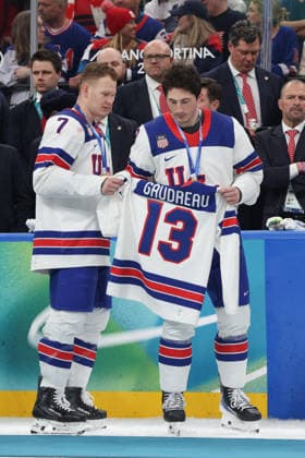 February 22, 2026: Brady Tkachuk (7) and Zach Werenski (8) of the United States display the jersey of Johnny Gaudreau (13) in memorium during the Gold medal ceremony following the Mens Ice hockey, Eishockey Gold Medal game between Canada and USA held at Milano Santagiulia Ice Hockey Arena during the Milano Cortina 2026 Olympic Games, Olympische Spiele, Olympia, OS in Milan, Italy. MilanoCortina2026 Olympics Milano Cortina 2026: Gold Medal Game Mens Ice Hockey Canada Vs United States Feb 22  - ZUMAc04_ 20260222_zma_c04_098 Copyright: xDanielxLeax