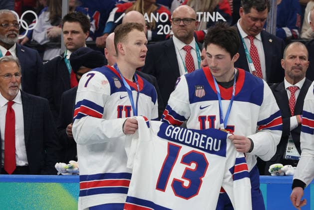 February 22, 2026: Brady Tkachuk (7) and Zach Werenski (8) of the United States display the jersey of Johnny Gaudreau (13) in memorium during the Gold medal ceremony following the Mens Ice hockey, Eishockey Gold Medal game between Canada and USA held at Milano Santagiulia Ice Hockey Arena during the Milano Cortina 2026 Olympic Games, Olympische Spiele, Olympia, OS in Milan, Italy. MilanoCortina2026 Milan Italy - ZUMAc04_ 20260222_zma_c04_112 Copyright: xDanielxLeax