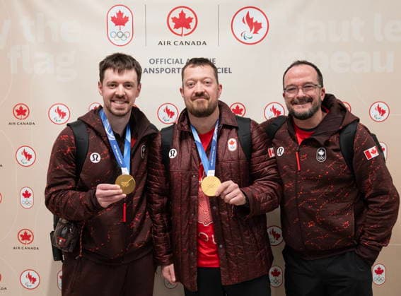 February 23, 2026, Calgary, Ab, CANADA: Canadian olympic curler and gold medalist Ben Hebert, centre, poses for a photo with teammate Tyler Tardi, left, and coach Paul Webster after they arrived at the Calgary International Airport after competing at the Milano Cortina Winter Olympics, Monday, Feb. 23, 2026. Canada News - February 23, 2026  - ZUMAc35_ 20260223_zaf_c35_118 Copyright: xToddxKorolx