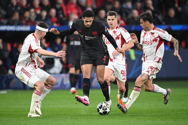 Jarell QUANSAH (LEV) Aktion, Zweikampf, gegen Lorenzo PIROLA (PI), Christos MOUZAKITIS (PI) und Dani GARCIA (PI) Fussball Champions League, Play Offs, Bayer 04 Leverkusen (LEV) - Olympiakos Piraeus (PI) am 24.02.2026 in Leverkusen Deutschland. UEFA regulations prohibit any use of photographs as image sequences and or quasi-video Â
