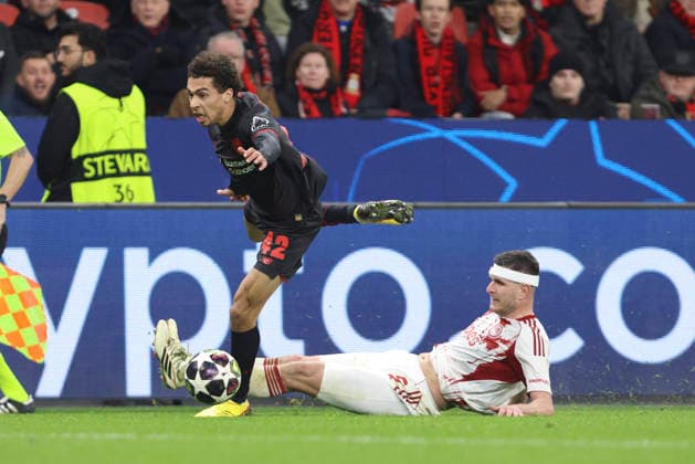 Montrell Culbreath (Bayer 04 Leverkusen) und Lorenzo Pirola (Olympiacos FC) battle for the ball during the UEFA Champions League 2025 26 League Knockout Play-off Second Leg match between Bayer 04 Leverkusen and Olympiacos FC at BayArena on February 24, 2026 in Leverkusen, Germany. (Photo by Oliver Kaelke DeFodi Images) -