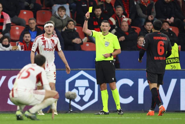 Lorenzo Pirola (Olympiacos FC) gets the yellow card during the UEFA Champions League 2025 26 League Knockout Play-off Second Leg match between Bayer 04 Leverkusen and Olympiacos FC at BayArena on February 24, 2026 in Leverkusen, Germany. (Photo by Oliver Kaelke DeFodi Images) -