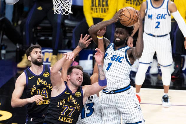 February 24, 2026, Los Angeles, California, USA: Orlando MagicÃ¢â‚¬â ¢s Jonathan Isaac (1) grabs a rebound against Los Angeles LakersÃ¢â‚¬â ¢ Luka DonÄÂiÄ¡ (77) during an NBA, Basketball Herren, USA basketball game at Crypto.com Arena on Tuesday, Feb. 24, 2026 in Los Angeles. NBA 2026: Magic 110:109 Lakers  - ZUMAc68_ 20260224_zaf_c68_059 Copyright: xRingoxChiux