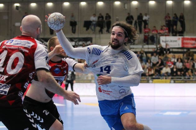 25.02.2026 Handball Herren 2025 2026 2. Handball-Bundesliga 21. Spieltag HSG Nordhorn-Lingen - Dessau-Roßlauer HV 06 EmslandArena Lingen Jakub Powarzynski (Dessau, 14, weiß) wird von Jaris Tobeler (Nordhorn, 25, rot) gehalten. Lingen (Ems) Niedersachen Deutschland