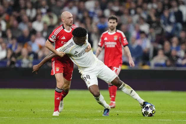 Real Madrid C.F. v SL Benfica - UEFA Champions League MADRID, SPAIN - FEBRUARY 25:Aurelien Tchouameni defensive midfield of Real Madrid and France and Fredrik Aursnes central midfield of Benfica and Norway compete for the ball during the UEFA Champions League 2025 26 League Knockout Play-off Second Leg match between Real Madrid C.F. and SL Benfica at Estadio Santiago Bernabeu on February 25, 2026 in Madrid, Spain. Jose Hernandez Anadolu Madrid Spain. Editorial use only. Please get in touch for any other usage.  Copyright: x2026xAnadoluxJosexHernandezx