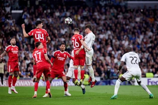 Raul Asencio of Real Madrid CF and Samuel Dahl of Benfica Real Madrid v Benfica, UEFA Champions League, Play-off, Leg 2, Football, Estadio Bernabeu, Madrid, Spain - 25 Feb 2026Madrid Estadio Bernabeu Spain EDITORIAL USE ONLY No use with unauthorised audio, video, data, fixture lists, club league logos or live services. Online in-match use limited to 120 images, no video emulation. No use in betting, games or single club league player publications. Copyright: xRubenxAlbarran Shutterstockx 16703182bt