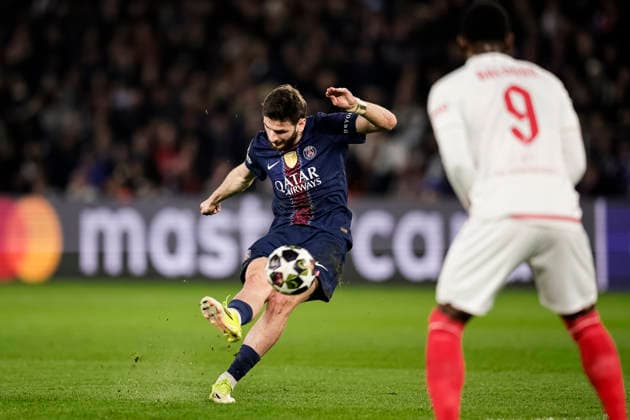 Paris, France - February 25: Khvicha Kvaratskhelia of Paris Saint Germain (L) attempts a kick while being defended by Folarin Balogun of Monaco (R) during the UEFA Champions League 2025 26 League Knockout Play-off Second Leg match between Paris Saint-Germain and AS Monaco at Parc des Princes on February 25, 2026 in Paris, France. (Photo by Antonio Borga Eurasia Images) Paris Parc des Princes France