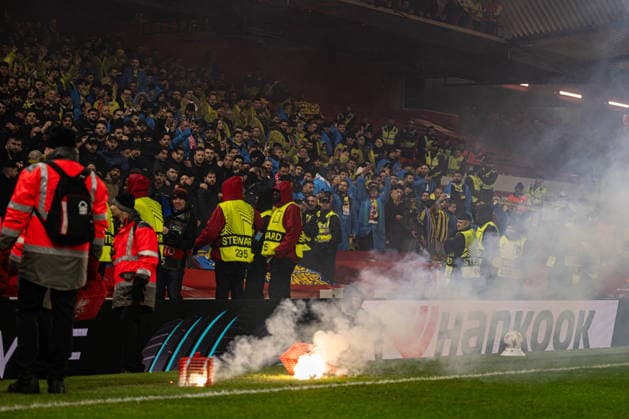 26th February 2026; The City Ground, Nottingham, England; UEFA Europa League Football, Nottingham Forest versus Fenerbahce; Smoke from the flares thrown by Fenerbahce SK fans and secured in wire cages  GodfreyxPitt Content restricted for UK based newspaper