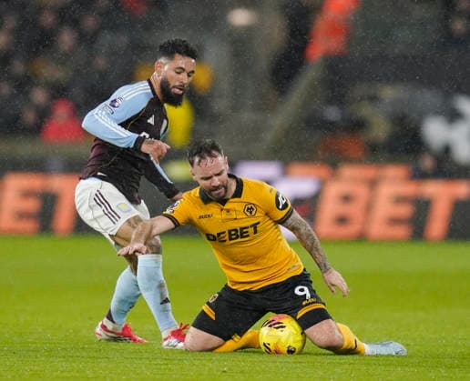 Wolverhampton, England, 27th February 2026. Douglas Luiz of Aston Villa brings down Adam Armstrong of Wolverhampton Wanderers during the Wolverhampton Wanderers vs Aston Villa Premier League match at Molineux, Wolverhampton. Picture credit should read: Andrew Yates Sportimage EDITORIAL USE ONLY. No use with unauthorised audio, video, data, fixture lists, club league logos or live services. Online in-match use limited to 120 images, no video emulation. No use in betting, games or single club league player publications. SPI_025_AY_Wolves_Villa SPI-4564-0025