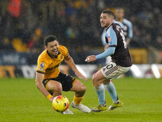 Wolverhampton, England, 27th February 2026. Andre of Wolverhampton Wanderers tackled by Emiliano Buendia of Aston Villa during the Wolverhampton Wanderers vs Aston Villa Premier League match at Molineux, Wolverhampton. Picture credit should read: Andrew Yates Sportimage EDITORIAL USE ONLY. No use with unauthorised audio, video, data, fixture lists, club league logos or live services. Online in-match use limited to 120 images, no video emulation. No use in betting, games or single club league player publications. SPI_029_AY_Wolves_Villa SPI-4564-0027