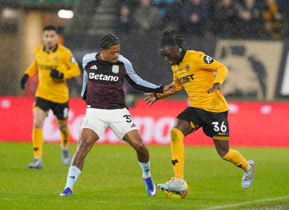 Wolverhampton, England, 27th February 2026. Leon Bailey of Aston Villa tussles with Mateus Mane of Wolverhampton Wanderers during the Wolverhampton Wanderers vs Aston Villa Premier League match at Molineux, Wolverhampton. Picture credit should read: Andrew Yates Sportimage EDITORIAL USE ONLY. No use with unauthorised audio, video, data, fixture lists, club league logos or live services. Online in-match use limited to 120 images, no video emulation. No use in betting, games or single club league player publications. SPI_037_AY_Wolves_Villa SPI-4564-0037