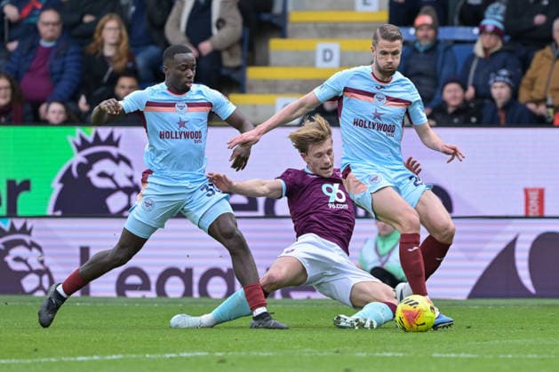 28th February 2026; Turf Moor, Burnley, Lancashire, England; Premier League Football, Burnley versus Brentford; Zian Flemming of Burnley is brought down during a challenge with Michael Kayode of Brentford  LeexDurkin