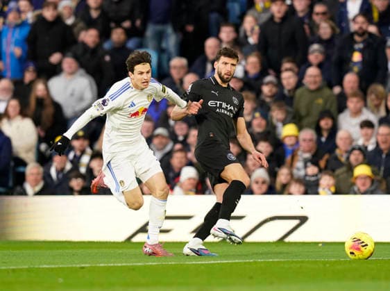 Leeds, England, 28th February 2026. Brenden Aaronson of Leeds United tussles with Ruben Dias of Manchester City during the Leeds United vs Manchester City Premier League match at Elland Road, Leeds. Picture credit should read: Andrew Yates Sportimage EDITORIAL USE ONLY. No use with unauthorised audio, video, data, fixture lists, club league logos or live services. Online in-match use limited to 120 images, no video emulation. No use in betting, games or single club league player publications. SPI_033_AY_Leeds_Man_City SPI-4565-0033