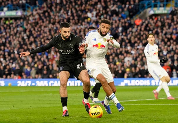 Leeds, England, 28th February 2026. Rayan Alt-Nouri of Manchester City tackles Jayden Bogle of Leeds United during the Leeds United vs Manchester City Premier League match at Elland Road, Leeds. Picture credit should read: Andrew Yates Sportimage EDITORIAL USE ONLY. No use with unauthorised audio, video, data, fixture lists, club league logos or live services. Online in-match use limited to 120 images, no video emulation. No use in betting, games or single club league player publications. SPI_038_AY_Leeds_Man_City SPI-4565-0038