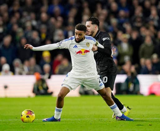 Leeds, England, 28th February 2026. Jayden Bogle of Leeds United and Rayan Cherki of Manchester City during the Leeds United vs Manchester City Premier League match at Elland Road, Leeds. Picture credit should read: Andrew Yates Sportimage EDITORIAL USE ONLY. No use with unauthorised audio, video, data, fixture lists, club league logos or live services. Online in-match use limited to 120 images, no video emulation. No use in betting, games or single club league player publications. SPI_052_AY_Leeds_Man_City SPI-4565-0052