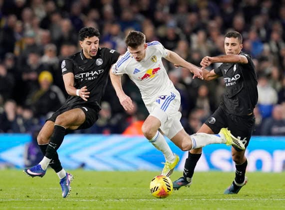Leeds, England, 28th February 2026. Omar Marmoush (l) and Rodri of Manchester City (r) tackle Anton Stach of Leeds United (c) during the Leeds United vs Manchester City Premier League match at Elland Road, Leeds. Picture credit should read: Andrew Yates Sportimage EDITORIAL USE ONLY. No use with unauthorised audio, video, data, fixture lists, club league logos or live services. Online in-match use limited to 120 images, no video emulation. No use in betting, games or single club league player publications. SPI_072_AY_Leeds_Man_City SPI-4565-0072