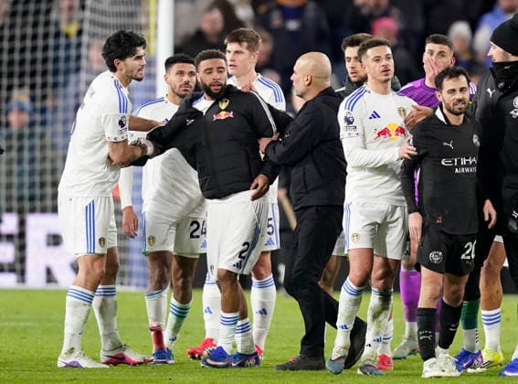 Leeds, England, 28th February 2026. Pep Guardiola coach of Manchester City holds back Jayden Bogle of Leeds United during the Leeds United vs Manchester City Premier League match at Elland Road, Leeds. Picture credit should read: Andrew Yates Sportimage EDITORIAL USE ONLY. No use with unauthorised audio, video, data, fixture lists, club league logos or live services. Online in-match use limited to 120 images, no video emulation. No use in betting, games or single club league player publications. SPI_096_AY_Leeds_Man_City SPI-4565-0097