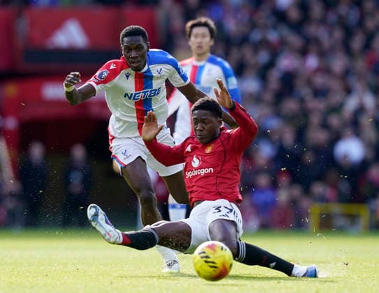 Manchester, England, 1st March 2026. Ismaila Sarr of Crystal Palace tussles with Kobbie Mainoo of Manchester United, ManU during the Manchester United vs Crystal Palace Premier League match at Old Trafford, Manchester. Picture credit should read: Andrew Yates Sportimage EDITORIAL USE ONLY. No use with unauthorised audio, video, data, fixture lists, club league logos or live services. Online in-match use limited to 120 images, no video emulation. No use in betting, games or single club league player publications. SPI_027_AY_Man_Utd_Palace SPI-4566-0027