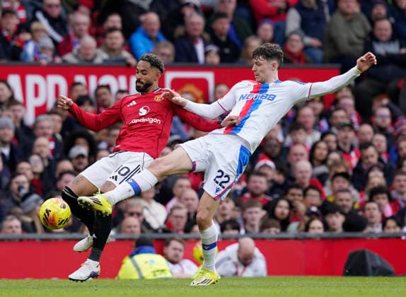 Manchester, England, 1st March 2026. Matheus Cunha of Manchester United, ManU tackled by Jorge Strand Larsen of Crystal Palace during the Manchester United vs Crystal Palace Premier League match at Old Trafford, Manchester. Picture credit should read: Andrew Yates Sportimage EDITORIAL USE ONLY. No use with unauthorised audio, video, data, fixture lists, club league logos or live services. Online in-match use limited to 120 images, no video emulation. No use in betting, games or single club league player publications. SPI_037_AY_Man_Utd_Palace SPI-4566-0037