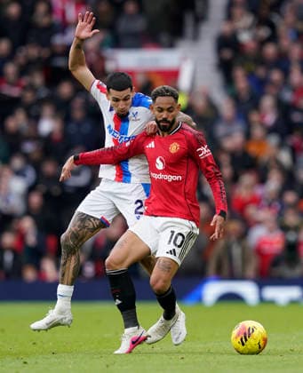 Manchester, England, 1st March 2026. Daniel Munoz of Crystal Palace tussles with Matheus Cunha of Manchester United, ManU during the Manchester United vs Crystal Palace Premier League match at Old Trafford, Manchester. Picture credit should read: Andrew Yates Sportimage EDITORIAL USE ONLY. No use with unauthorised audio, video, data, fixture lists, club league logos or live services. Online in-match use limited to 120 images, no video emulation. No use in betting, games or single club league player publications. SPI_082_AY_Man_Utd_Palace SPI-4566-0082
