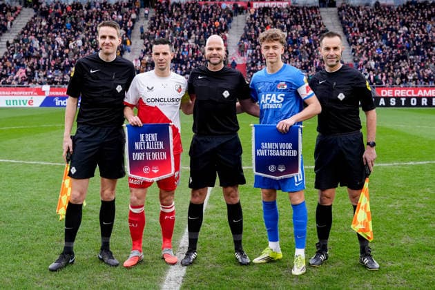 2026-03-01 FC Utrecht v AZ - Dutch Eredivisie UTRECHT, NETHERLANDS - MARCH 1: Assistant Referee Erik Koopman, Nick Viergever of FC Utrecht and Sven Mijnans of AZ Alkmaar holding their respective flags, the inscription reads on the left Je bent niet alleen, durf te delen and on the right Samen voor kweesbaarheid, Referee Rob Dieperink, Assistant Referee Mario Diks prior to the Dutch Eredivisie match between FC Utrecht and AZ at Stadion Galgenwaard on March 1, 2026 in Utrecht, Netherlands. Utrecht Stadion Galgenwaard Netherlands Content not available for redistribution in The Netherlands directly or indirectly through any third parties. Copyright: xEdxvanxdexPolx