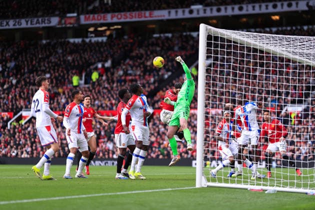 Football - Premier League - Manchester United, ManU v Crystal Palace 1st March 2026 - Premier League - Manchester United v Crystal Palace - Crystal Palace goalkeeper Dean Henderson punches the ball clear under pressure from Matheus Cunha of Manchester United - Photo: Simon Stacpoole Offside. Manchester UK Copyright: xSimonxStacpoolexOffside