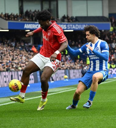 Ola Aina of Nottingham Forest shields the ball from Ferdi Kadioglu of Brighton during the Premier League match between Brighton and Hove Albion and Nottingham Forest at the American Express Stadium, Brighton UK - Sunday 1st March 2026 Brighton v Nottingham Forest Premier League Football, Amex Stadium, Sussex, UK - 01 Mar 2026Brighton Amex Stadium Sussex United Kingdom Editorial use only. No merchandising. For Football images FA and Premier League restrictions apply inc. no internet mobile usage without FAPL license - for details contact Football Dataco  Copyright: xLizxFinlayson TPI Shutterstockx 16718466bl