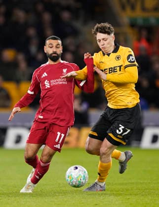 Wolverhampton, England, 3rd March 2026. Mohamed Salah of Liverpool tussles with Ladislav Krejci of Wolverhampton Wanderers during the Wolverhampton Wanderers vs Liverpool Premier League match at Molineux, Wolverhampton. Picture credit should read: Andrew Yates Sportimage EDITORIAL USE ONLY. No use with unauthorised audio, video, data, fixture lists, club league logos or live services. Online in-match use limited to 120 images, no video emulation. No use in betting, games or single club league player publications. SPI_031_AY_Wolves_Liverpool SPI-4574-0028