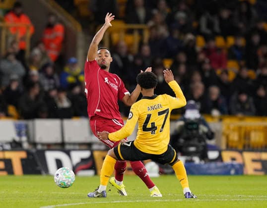 Wolverhampton, England, 3rd March 2026. Ryan Gravenberch of Liverpool tussles with Angel Gomes of Wolverhampton Wanderers during the Wolverhampton Wanderers vs Liverpool Premier League match at Molineux, Wolverhampton. Picture credit should read: Andrew Yates Sportimage EDITORIAL USE ONLY. No use with unauthorised audio, video, data, fixture lists, club league logos or live services. Online in-match use limited to 120 images, no video emulation. No use in betting, games or single club league player publications. SPI_036_AY_Wolves_Liverpool SPI-4574-0033