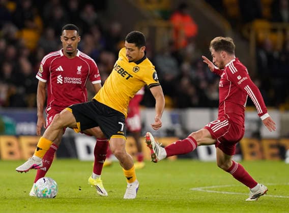 Wolverhampton, England, 3rd March 2026. Andre of Wolverhampton Wanderers tackled by Alexis Mac Allister of Liverpool (r) during the Wolverhampton Wanderers vs Liverpool Premier League match at Molineux, Wolverhampton. Picture credit should read: Andrew Yates Sportimage EDITORIAL USE ONLY. No use with unauthorised audio, video, data, fixture lists, club league logos or live services. Online in-match use limited to 120 images, no video emulation. No use in betting, games or single club league player publications. SPI_042_AY_Wolves_Liverpool SPI-4574-0039