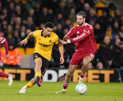 Wolverhampton, England, 3rd March 2026. Andre of Wolverhampton Wanderers tussles with Dominik Szoboszlai of Liverpool during the Wolverhampton Wanderers vs Liverpool Premier League match at Molineux, Wolverhampton. Picture credit should read: Andrew Yates Sportimage EDITORIAL USE ONLY. No use with unauthorised audio, video, data, fixture lists, club league logos or live services. Online in-match use limited to 120 images, no video emulation. No use in betting, games or single club league player publications. SPI_049_AY_Wolves_Liverpool SPI-4574-0047
