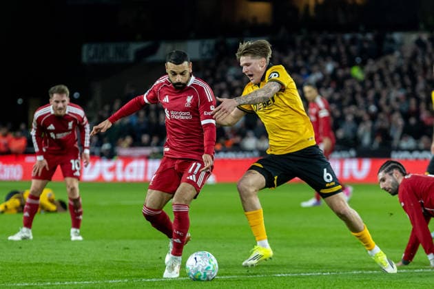 Wolverhampton Wanderers v Liverpool, Premier League Liverpool forward Mohamed Salah (11) battles for possession with Wolverhampton Wanderers defender David Moller Wolfe (6) during the Premier League match between Wolverhampton Wanderers and Liverpool at Molineux, Wolverhampton, UK on 3 March 2026. Wolverhampton Molineux West Midlands UK Editorial use only DataCo restrictions apply See www.football-dataco.com , Copyright: xManjitxNarotrax PSI-23833-0022