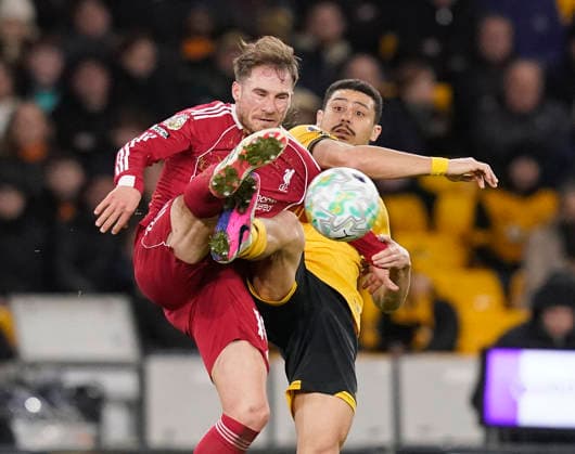 Wolverhampton, England, 3rd March 2026. Alexis Mac Allister of Liverpool and Andre of Wolverhampton Wanderers Wanderers during the Wolverhampton Wanderers vs Liverpool Premier League match at Molineux, Wolverhampton. Picture credit should read: Andrew Yates Sportimage EDITORIAL USE ONLY. No use with unauthorised audio, video, data, fixture lists, club league logos or live services. Online in-match use limited to 120 images, no video emulation. No use in betting, games or single club league player publications. SPI_059_AY_Wolves_Liverpool SPI-4574-0056