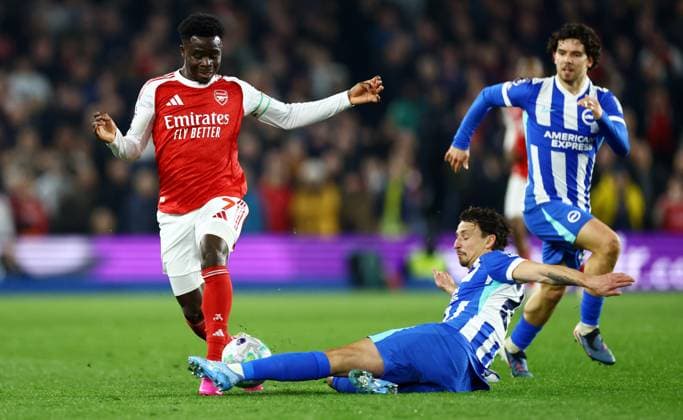 Bukayo Saka of Arsenal is tackled by Olivier Boscagli of Brighton and Hove Albion. Brighton and Hove Albion v Arsenal, Premier League, Football, American Express Community Stadium, Brighton, UK - 04 Mar 2026Brighton American Express Community Stadi United Kingdom EDITORIAL USE ONLY No use with unauthorised audio, video, data, fixture lists, club league logos or live services. Online in-match use limited to 120 images, no video emulation. No use in betting, games or single club league player publications.  Copyright: xJamesxMarsh Shutterstockx 16720017am